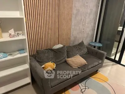 Cozy living room with modern decor and comfortable gray sofa