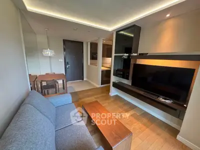 Modern living room with sleek furniture and ambient lighting in a stylish apartment.