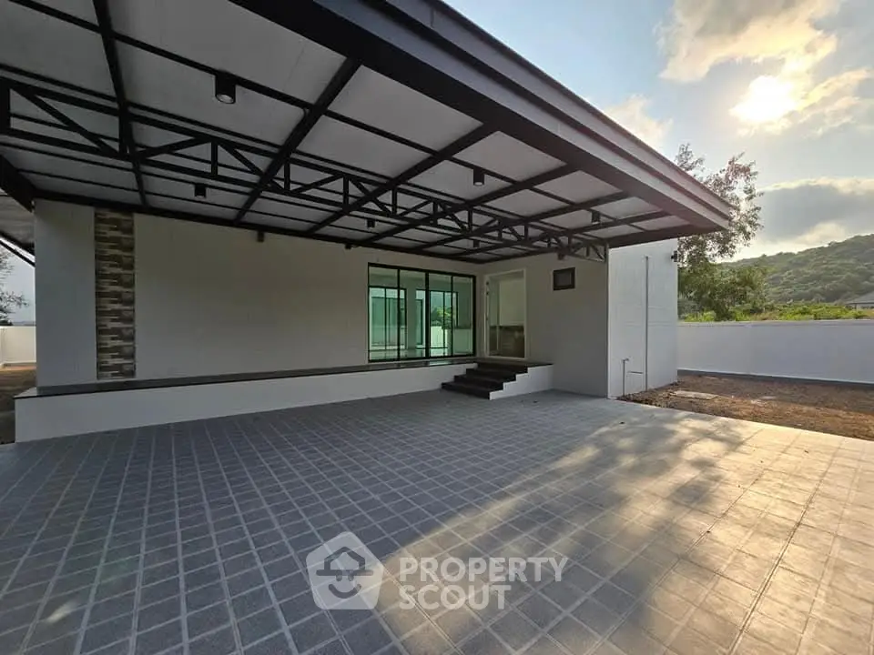 Modern single-story home with spacious covered patio and scenic mountain views.