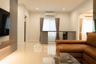 Spacious modern living room with leather sofa and natural light