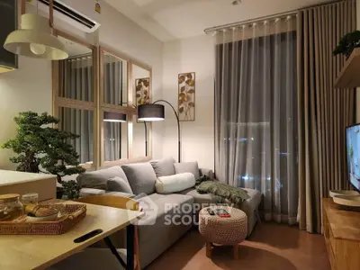 Cozy modern living room with stylish decor and large window for natural light.