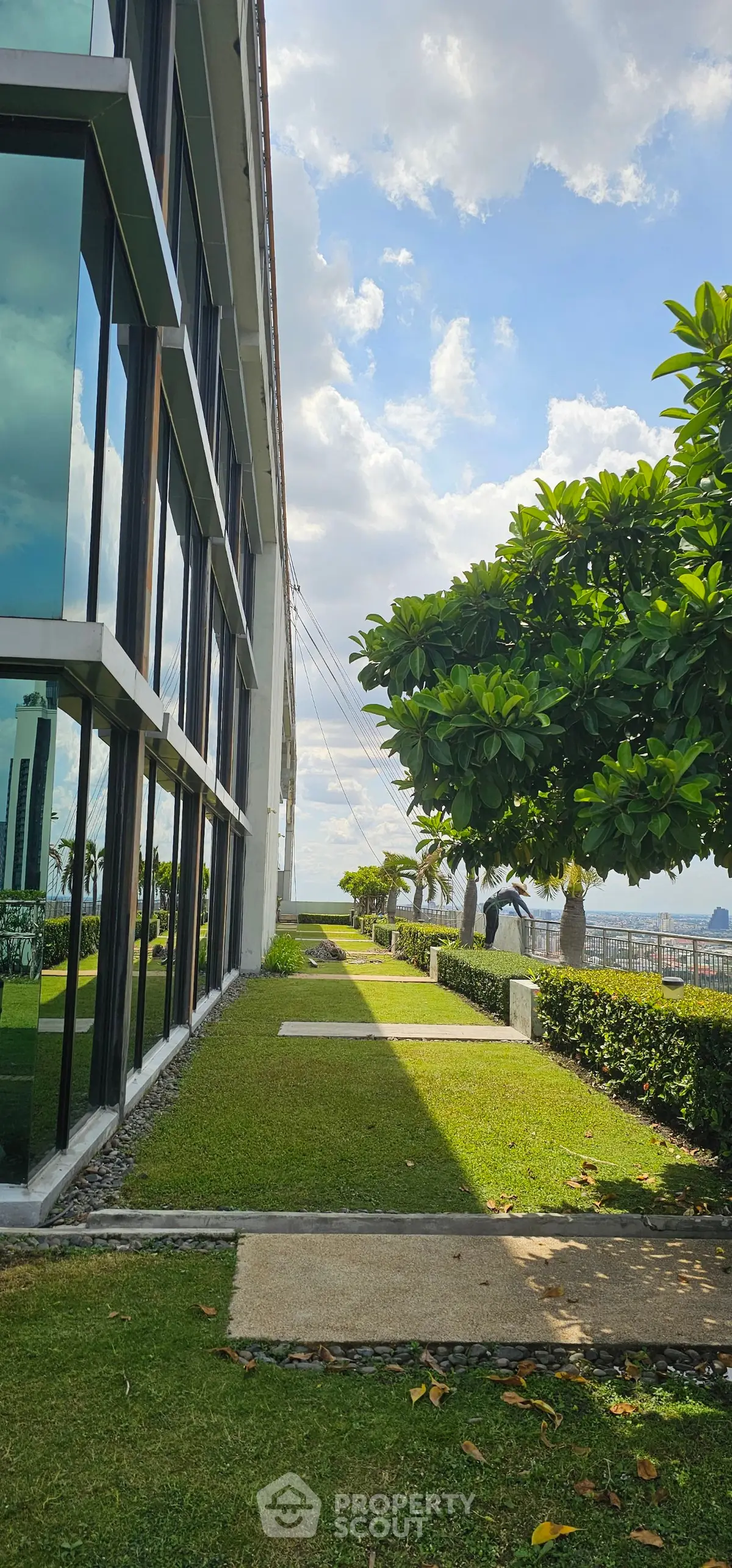 Modern building exterior with lush garden and scenic view