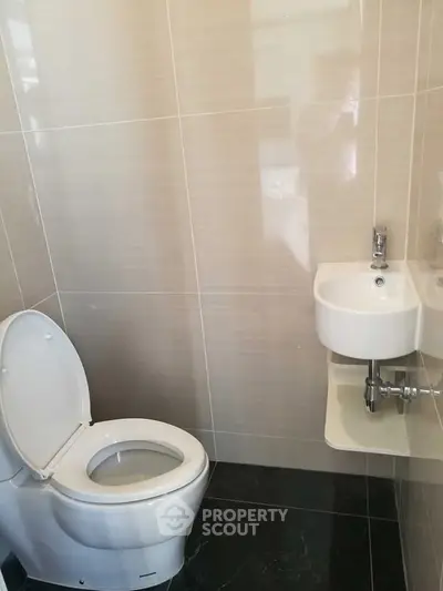 Modern bathroom with sleek toilet and compact sink
