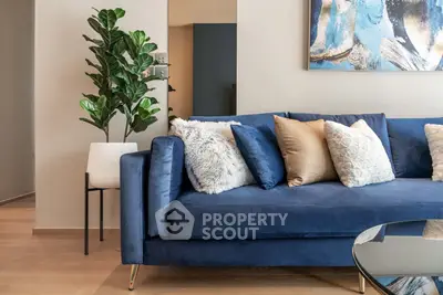 Stylish modern living room with blue sofa and decorative pillows
