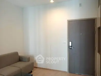 Modern minimalist living room with sofa and sleek entrance door