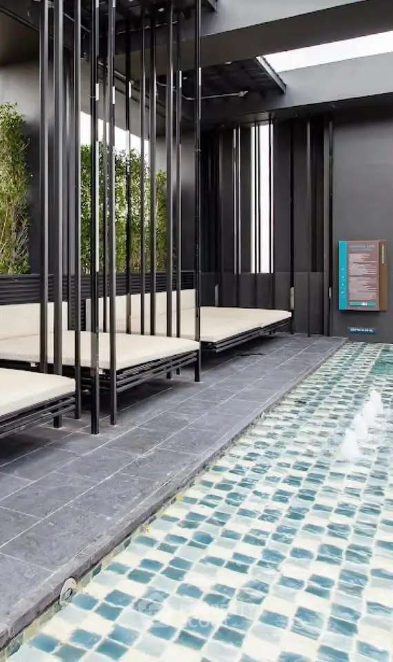 Luxurious rooftop pool area with modern design and stylish seating, perfect for relaxation and entertainment.