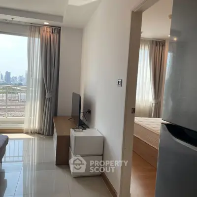 Modern apartment interior with city view, featuring a cozy living area and bedroom.