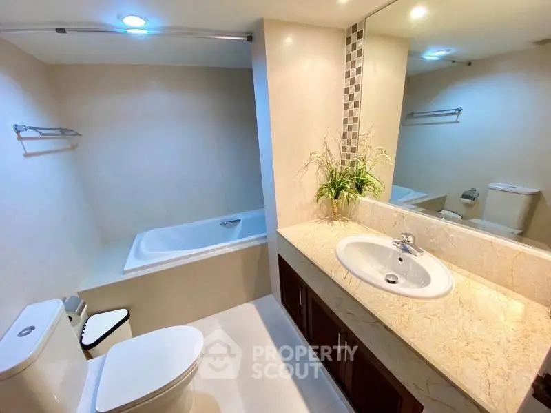 Modern bathroom with elegant fixtures and a relaxing bathtub in a stylish apartment.