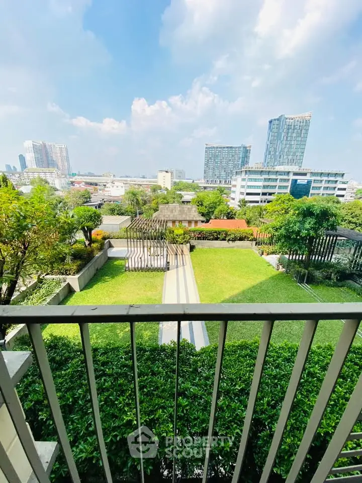 Stunning cityscape view from a lush green garden balcony in a modern urban setting.
