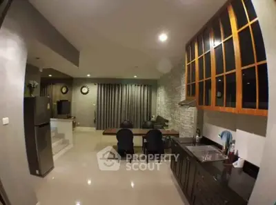 Modern kitchen and dining area with sleek cabinets and open layout