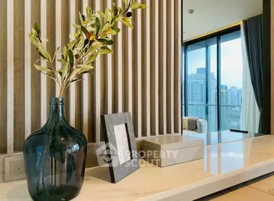 Modern interior with elegant decor and city view from large window.