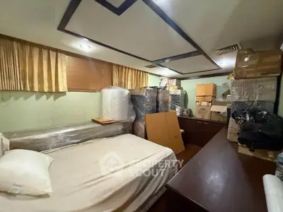 Cozy storage room with bed and packed boxes, ideal for organizing belongings.