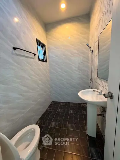 Modern bathroom with sleek tiles and minimalist fixtures in a contemporary home.