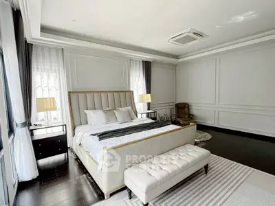Luxurious bedroom with elegant decor and ample natural light