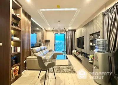 Elegantly furnished living room with plush seating and modern amenities, leading to a balcony with a stunning cityscape view, perfect for urban living.