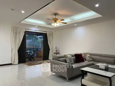 Spacious living room with elegant decor and balcony access