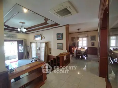 Spacious living and dining area with elegant wooden accents and ample natural light.