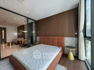 Modern bedroom with stylish decor and large windows offering city views