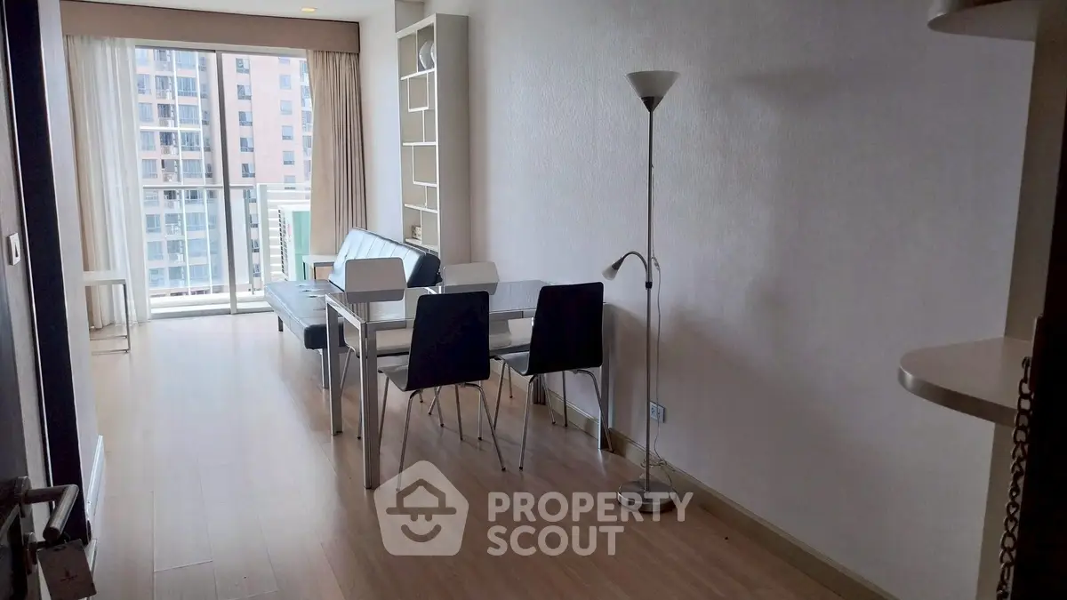 Modern living room with dining area and large windows offering city view