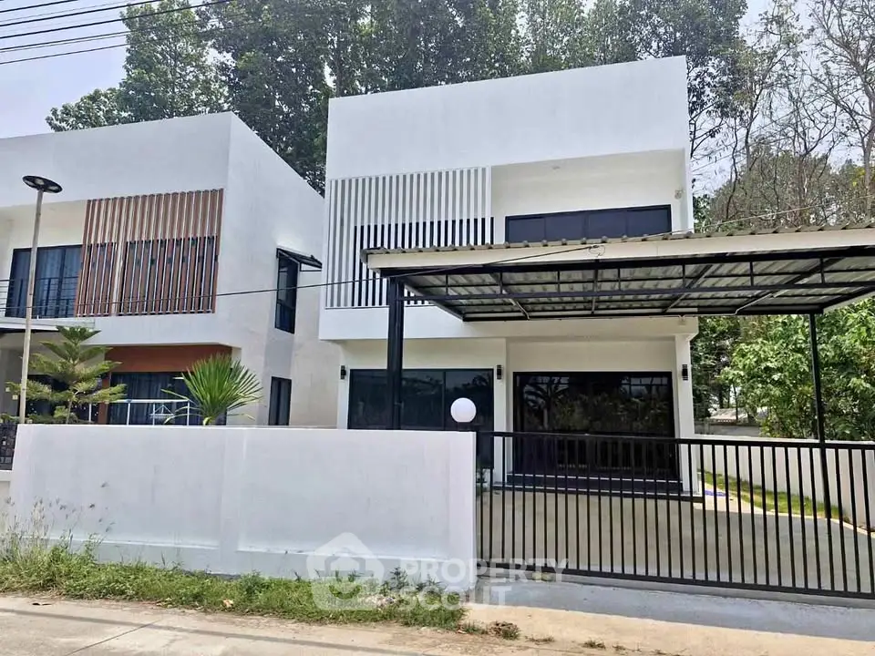 Modern two-story house with sleek design and spacious driveway in a serene neighborhood.