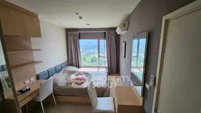 Cozy bedroom with stunning city view, modern furniture, and ample natural light.