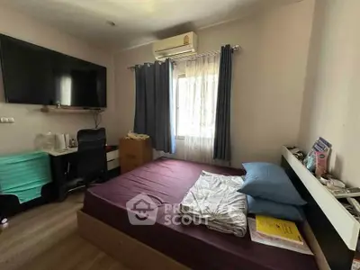 Cozy bedroom with modern amenities and natural light