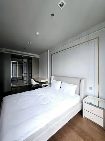 Luxurious modern bedroom with elegant decor and ample natural light.