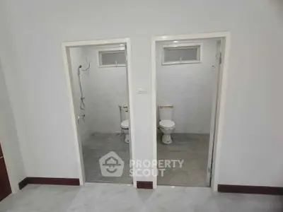 Dual bathroom setup with modern fixtures and minimalist design.