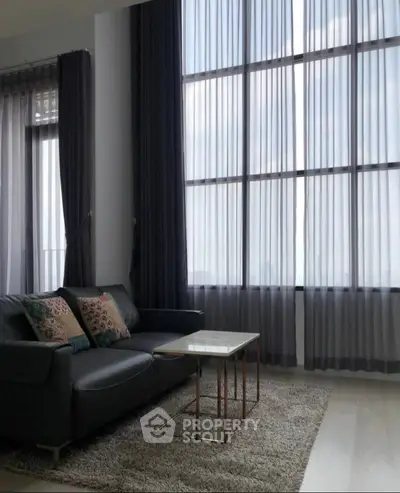 Spacious living room with large windows and modern decor
