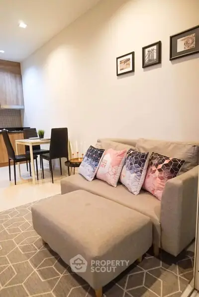 Cozy living room with modern decor and dining area in open layout apartment.