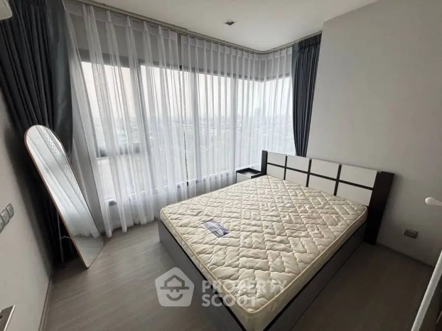 Spacious bedroom with large windows and modern decor