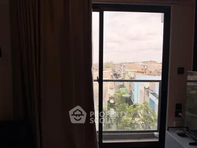 Spacious room with large window offering urban view, perfect for city living.