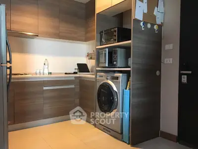 Modern kitchen with sleek appliances and wooden cabinetry