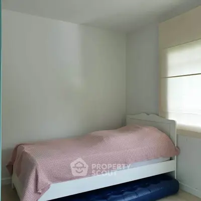 Cozy bedroom with single bed and natural light, perfect for a peaceful retreat.