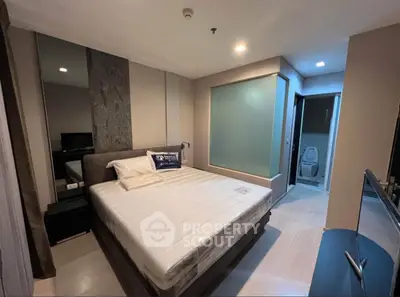 Modern bedroom with ensuite bathroom in stylish apartment