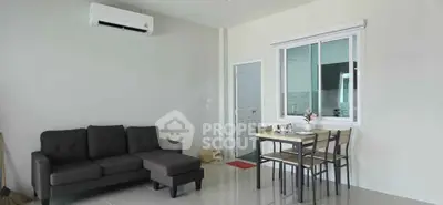 Modern living room with sleek furniture and dining area in open layout