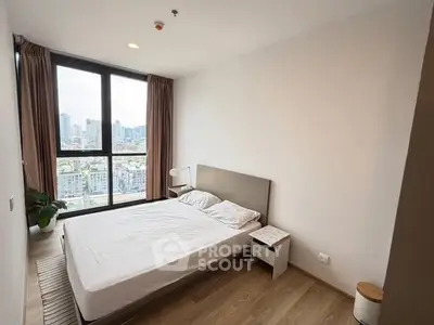 Modern bedroom with city view and minimalist design in high-rise apartment.