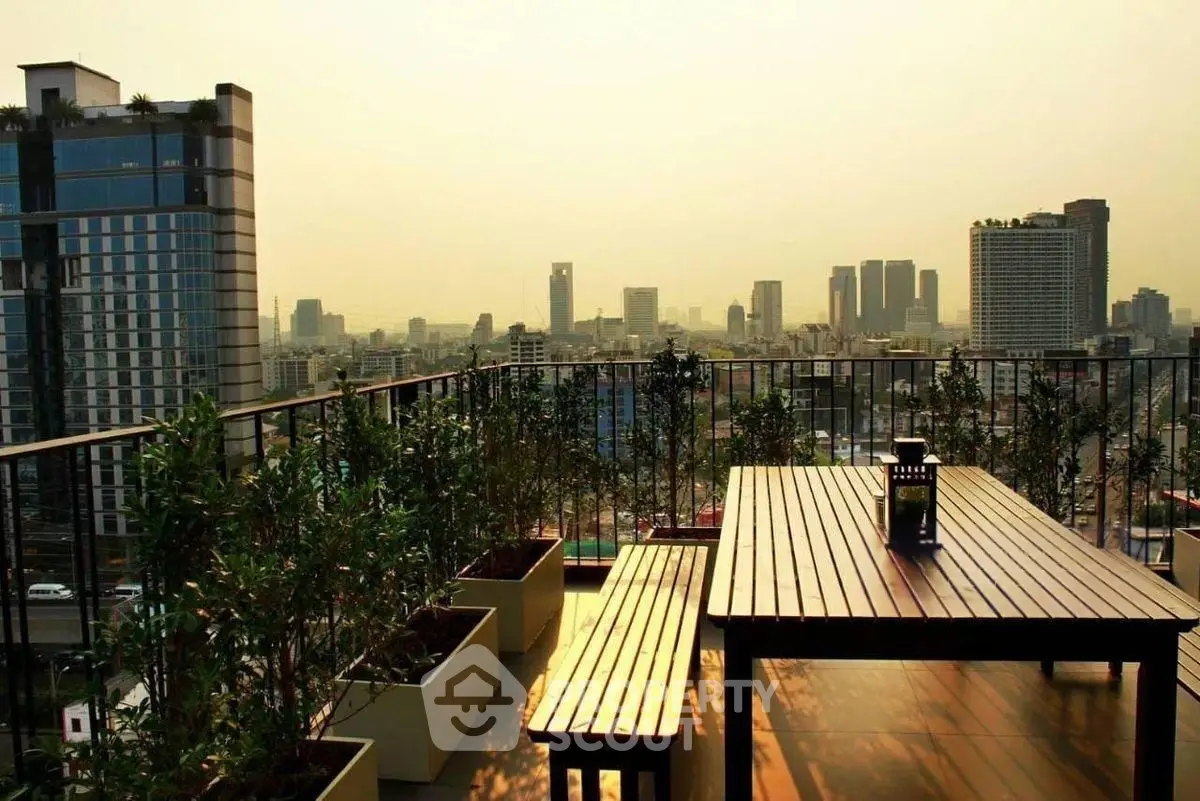 Stunning rooftop terrace with panoramic city skyline views at sunset.