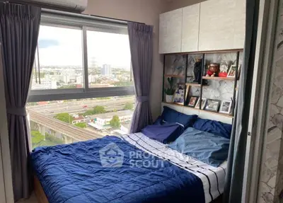 Cozy bedroom with large window offering stunning city view, modern decor, and ample natural light.