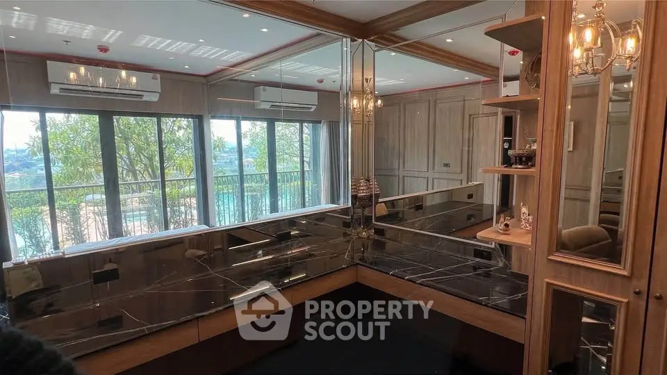 Luxurious living room with mirrored walls and large windows overlooking a scenic view.