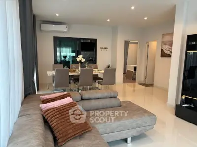 Spacious modern living room with elegant dining area and cozy sectional sofa.