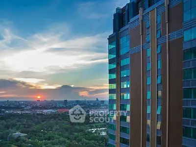 Stunning cityscape view from a modern high-rise building at sunset, showcasing urban living.