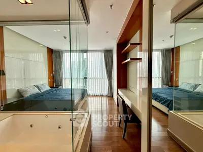 Luxurious bedroom with glass partition and elegant wooden flooring
