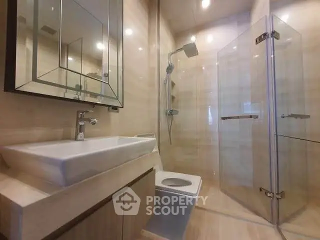 Modern bathroom with glass shower and sleek fixtures