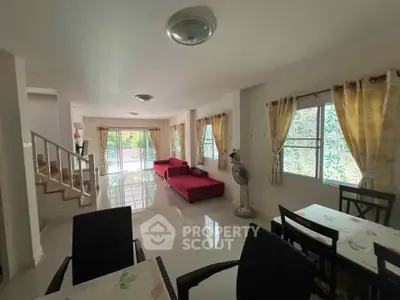 Spacious living room with modern decor and large windows for natural light.
