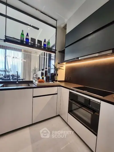 Modern kitchen with sleek cabinetry and built-in appliances in a stylish apartment.
