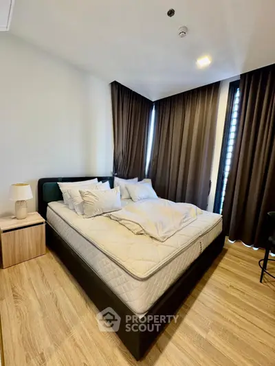 Modern bedroom with cozy bed and elegant curtains in a stylish apartment