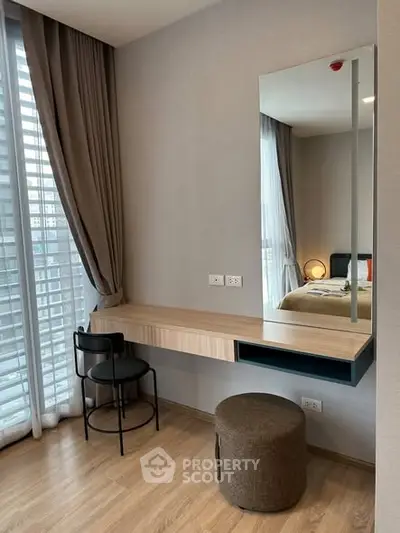 Modern bedroom with stylish vanity and large window for natural light