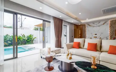 Luxurious living room with pool view, modern decor, and elegant furnishings in a contemporary home.