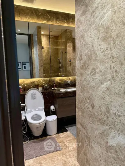 Luxurious marble bathroom with modern fixtures and elegant lighting